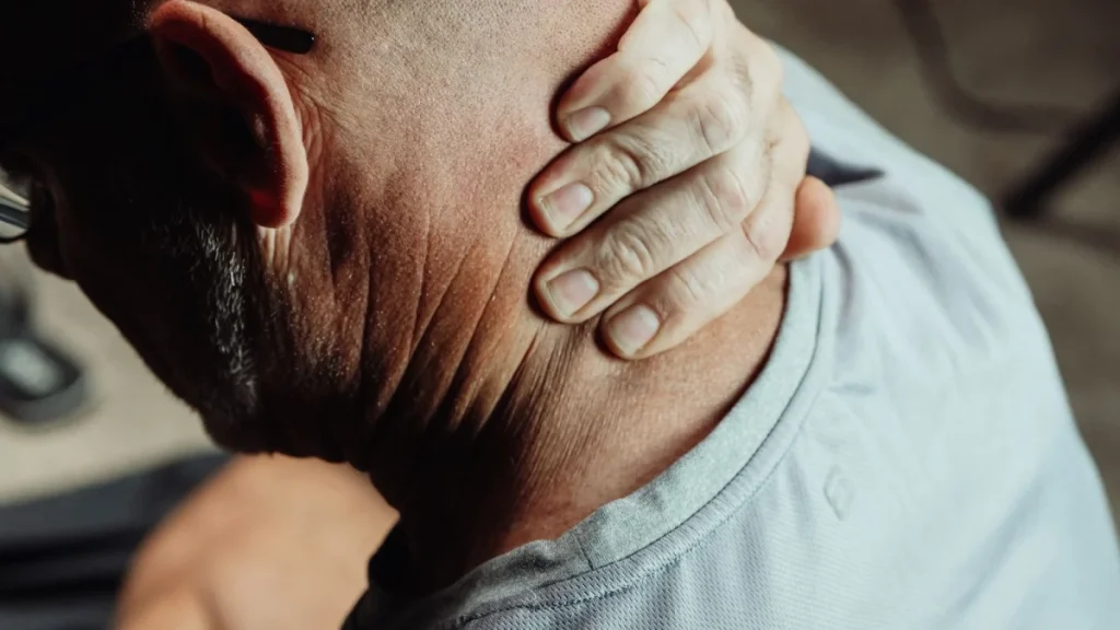 Man holding his painful neck, one of the most common car accident injuries