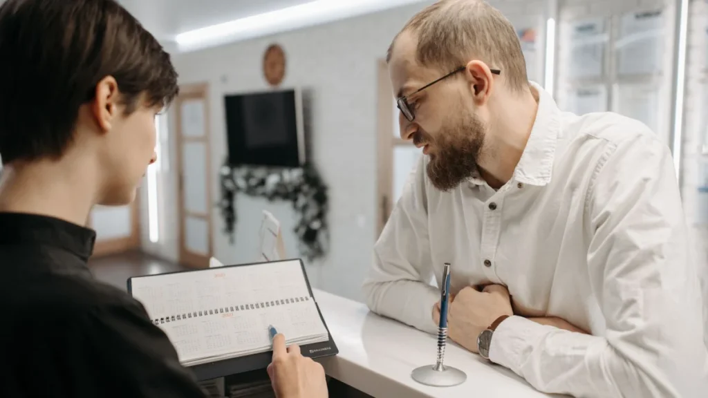 Receptionist booking a patient appointment, a key part of running a chiropractic practice