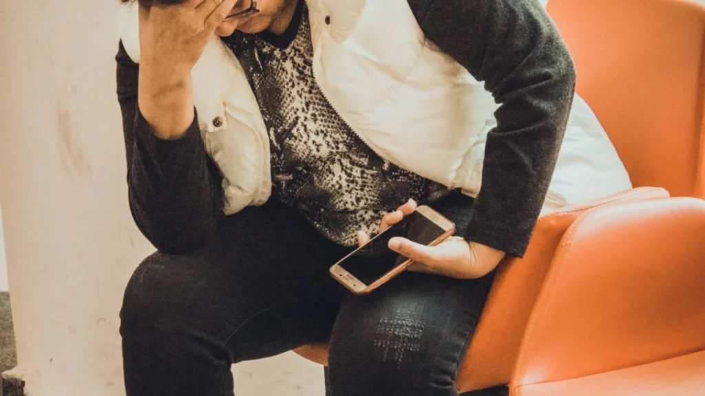 Worried woman in a waiting room, showing the emotional toll after a car accident