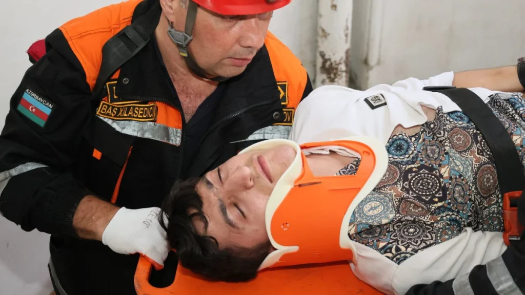 Emergency medical technician assisting an injured person after a car accident