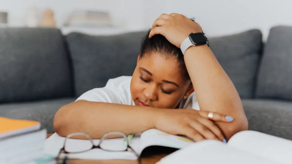 Woman with her hand on her head, feeling the daily weight of fibromyalgia