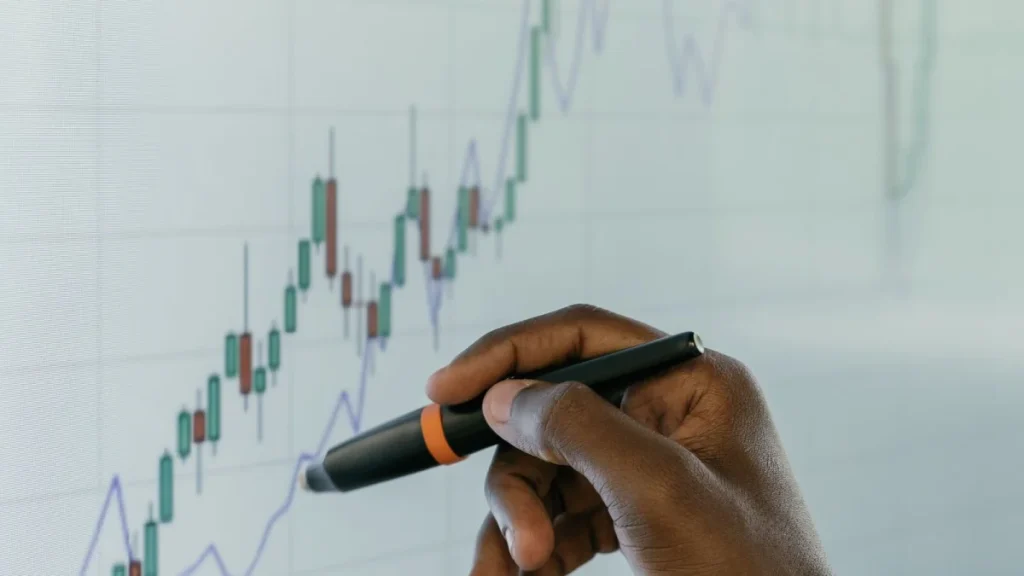 Hand reviewing a growth chart, showing factors that shape chiropractor salaries