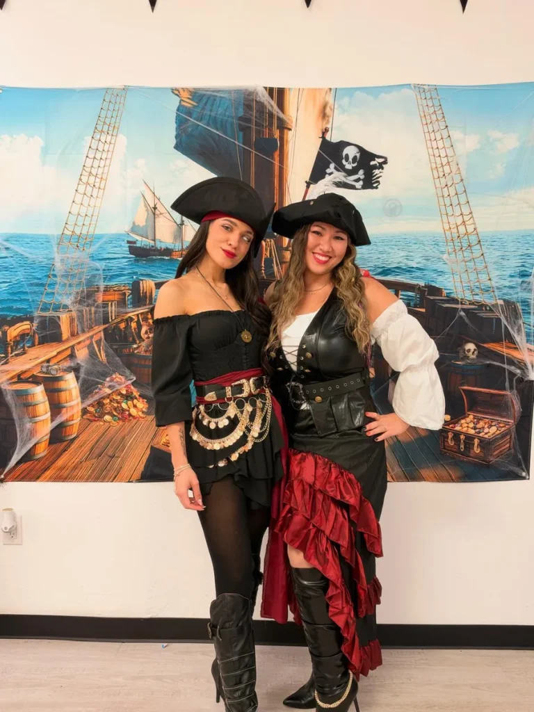 Two Spine and Injury Associates Haines City team members dressed as pirate captains