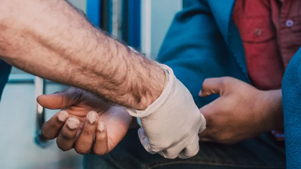 Paramedic giving first aid to an injured man, showing why immediate care matters