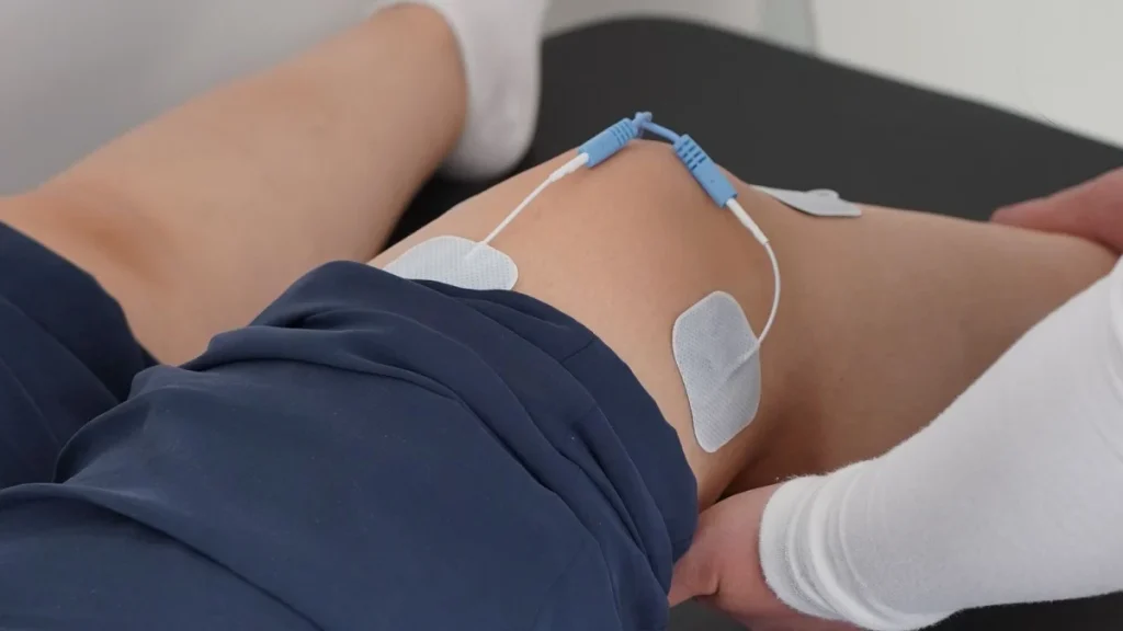 Therapist working on a patient's knee during joint injury treatment