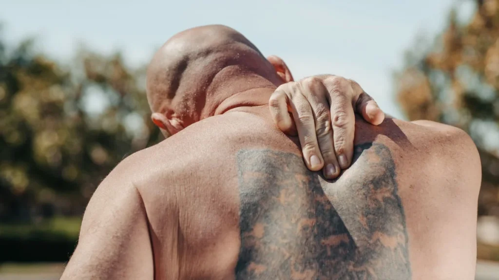 Man holding his back to show how untreated crash injuries can become chronic