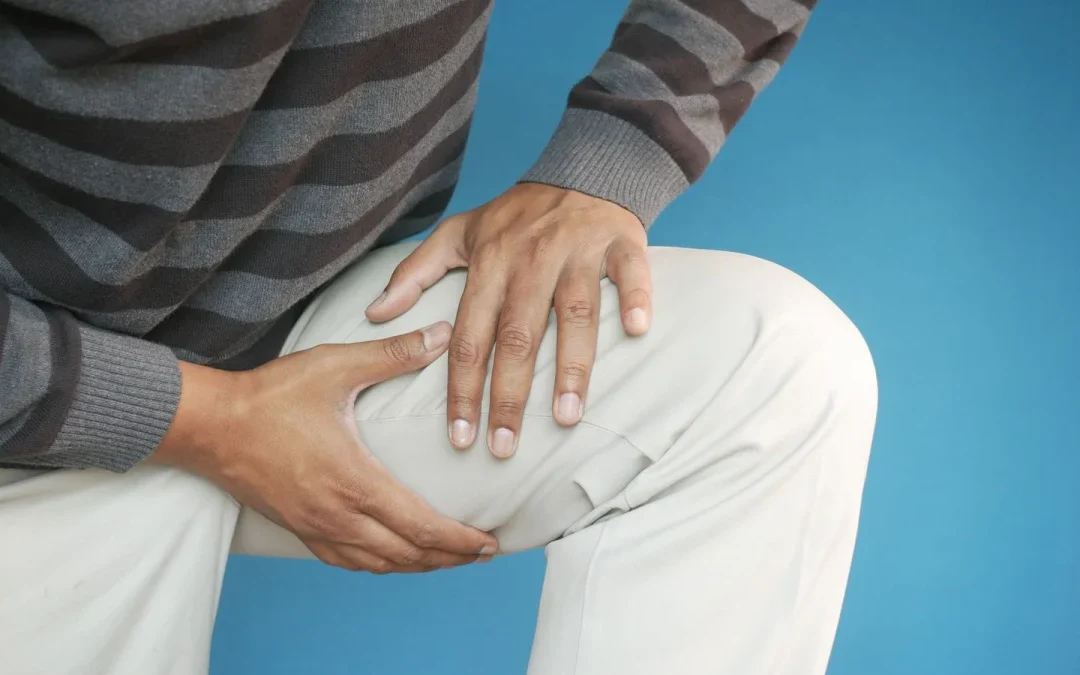 Man holding his thigh in pain from sciatica nerve pain running down the leg