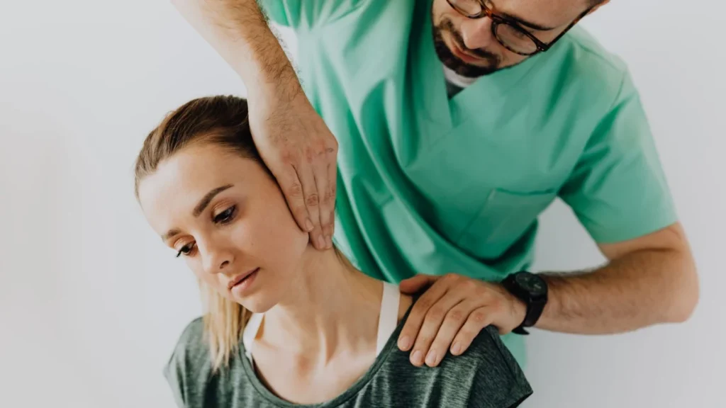 Practitioner treating a woman's neck to ease tension after a head injury