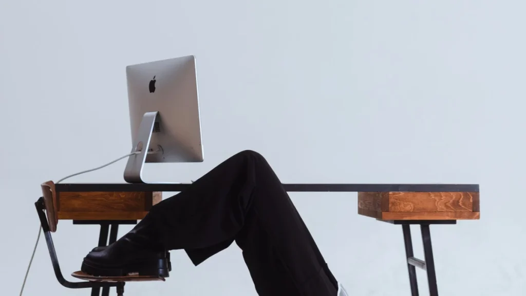 Woman stretching her back at her office chair to prevent back pain and sciatica