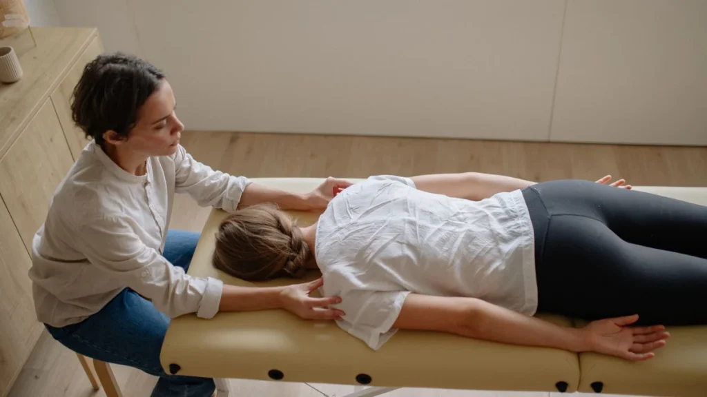 Woman lying face down on a treatment table, relaxed before safe chiropractic care