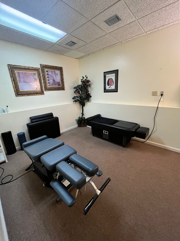 Chiropractic adjustment tables in a treatment room at the Ocala clinic