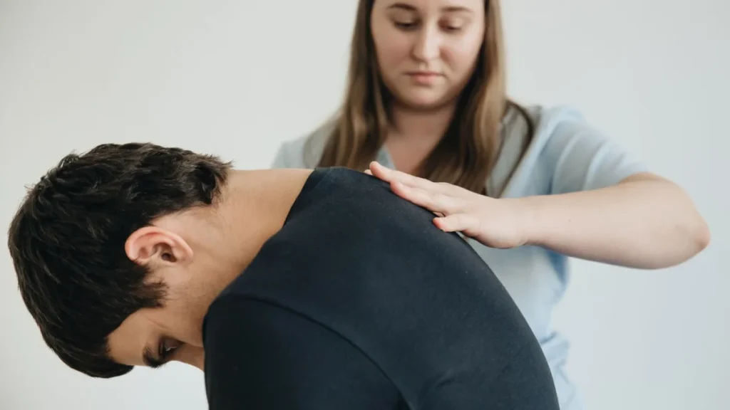 Therapist guiding a patient through back exercises to treat a herniated disc
