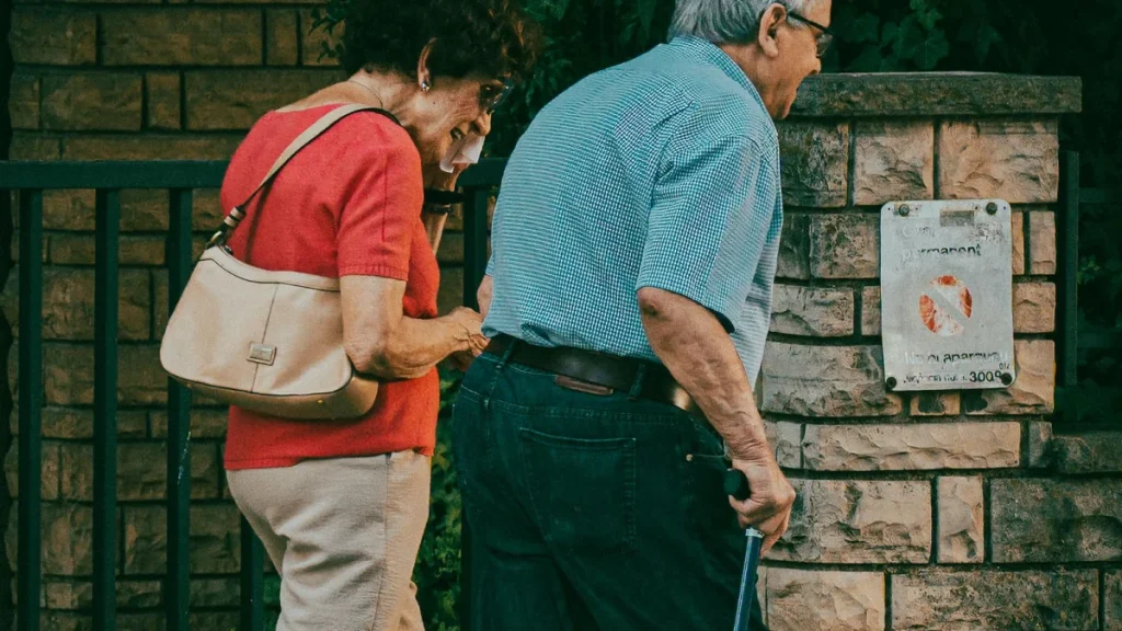 Couple enjoying a sunny walk outdoors after finding lasting sciatica relief