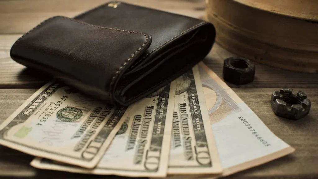 Wallet on top of dollar bills, summing up how much chiropractors make