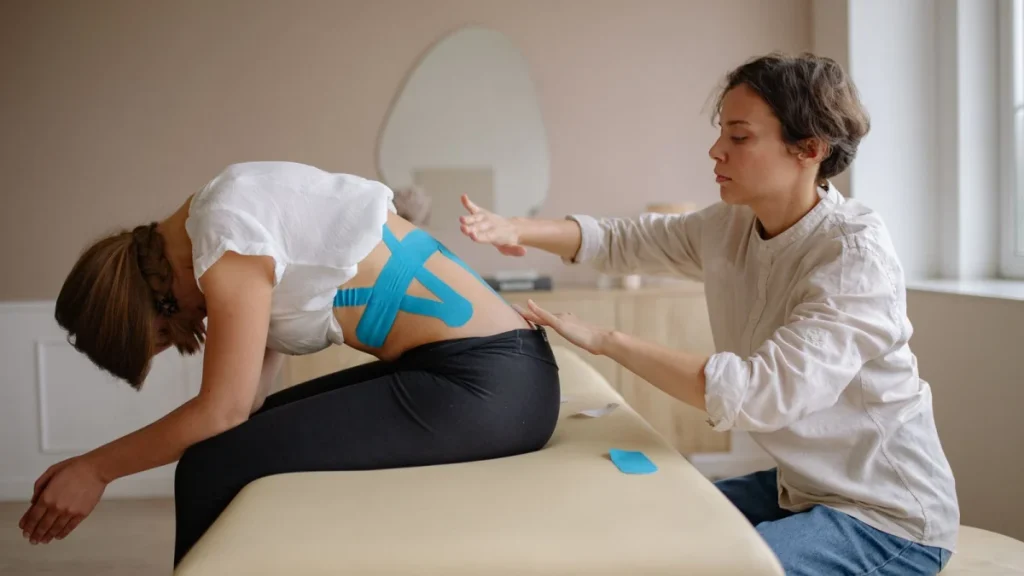 Practitioner treating a patient as part of a plan for low back pain relief