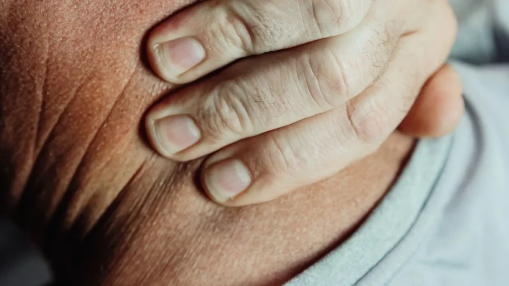 Person holding a painful neck, the hallmark of a whiplash injury