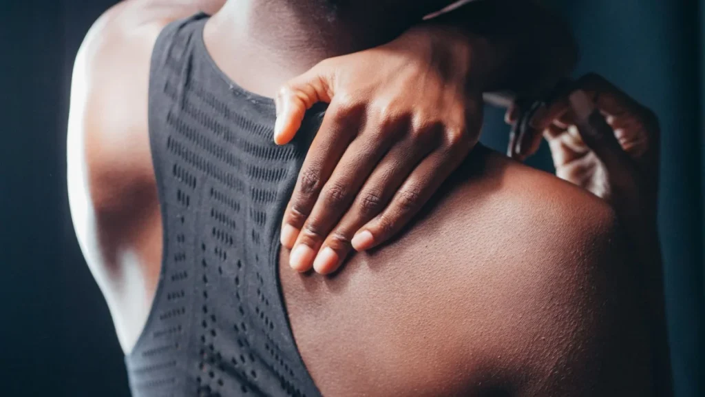 Woman holding her back as lower back pain lingers and care is needed