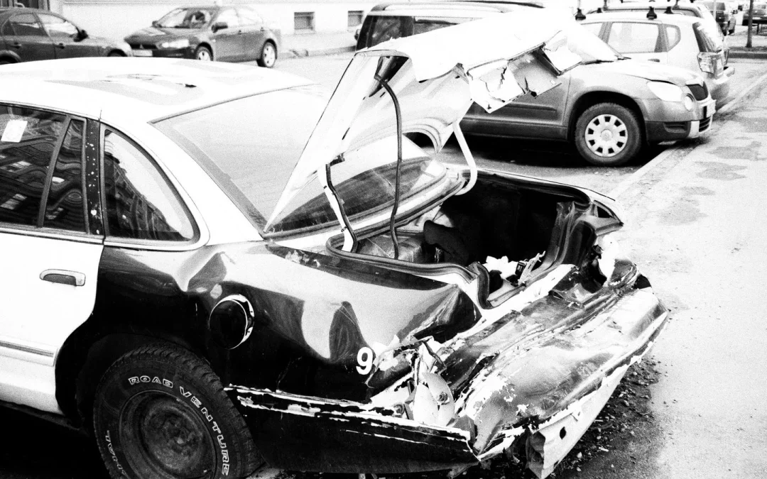 Wrecked car on a city street, showing why early chiropractic care matters