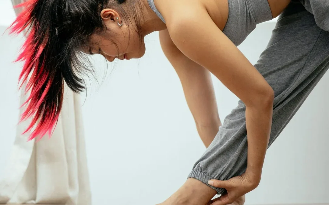 Woman in a yoga pyramid stretch to help prevent back pain and sciatica